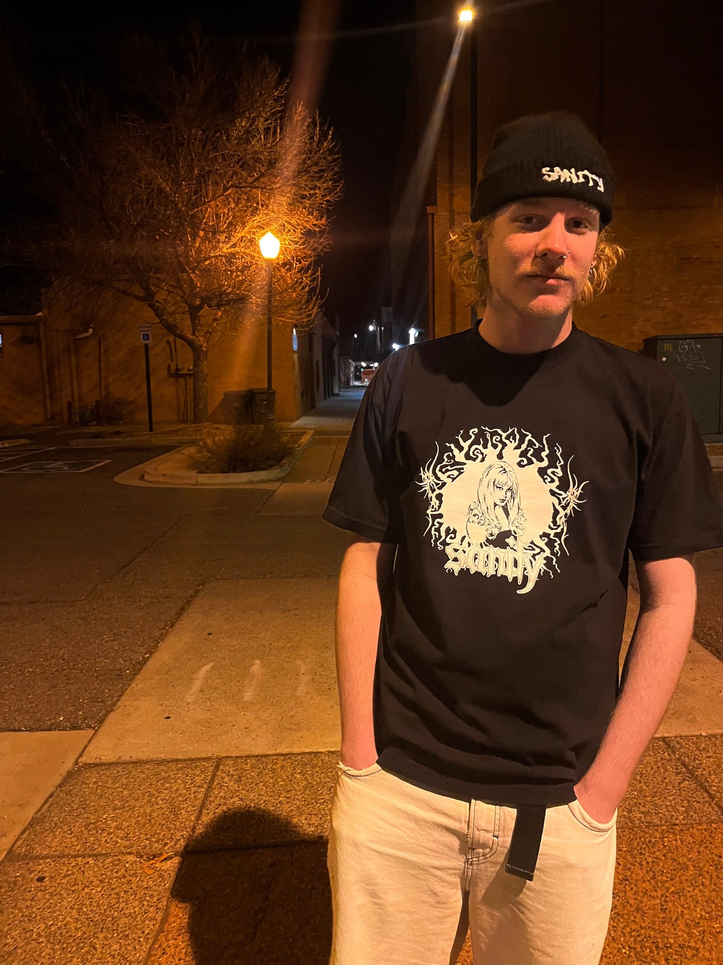 Model wearing black GIRL t-shirt, size large fit demonstration