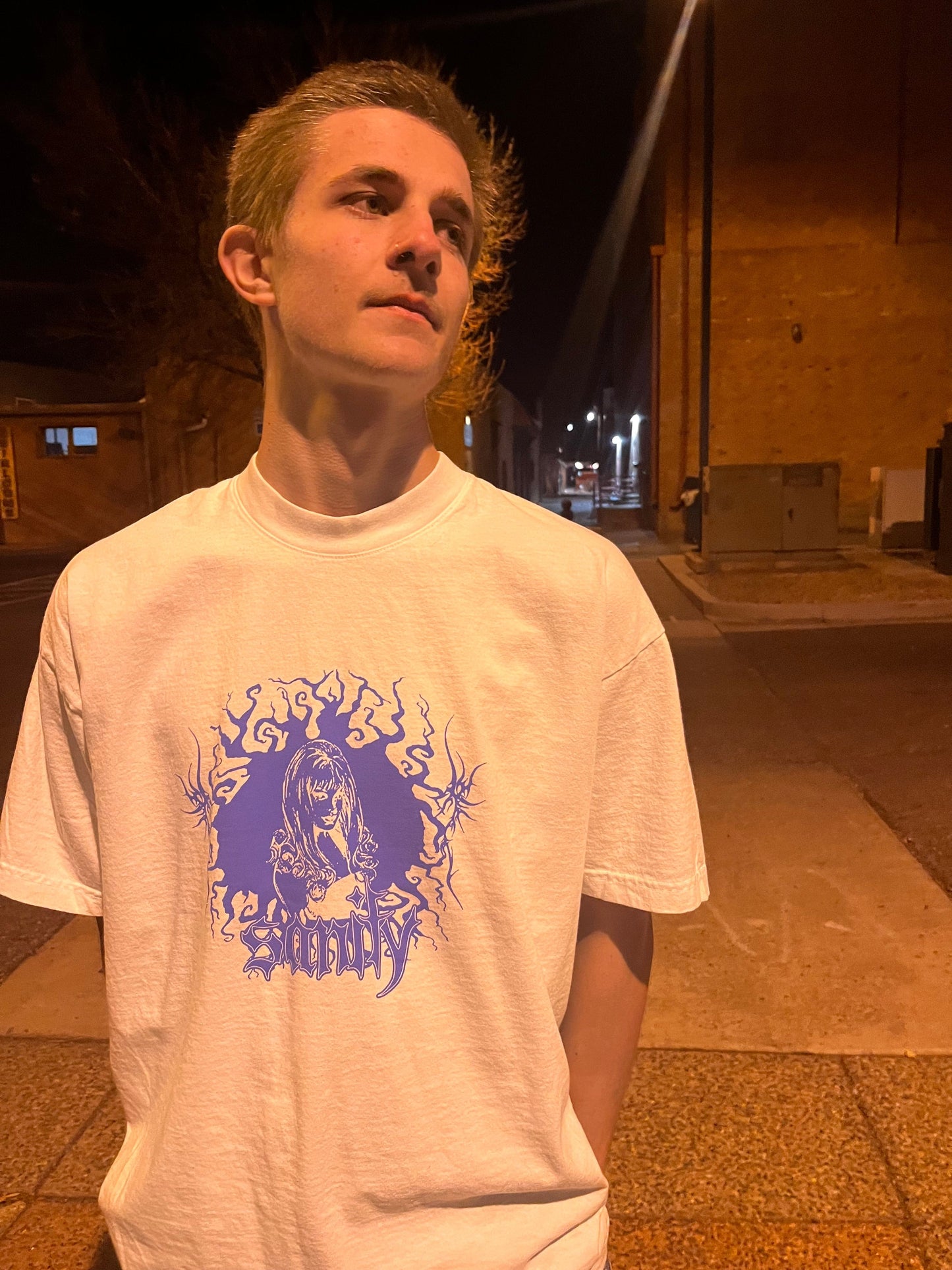 Model wearing white GIRL t-shirt, size large fit demonstration